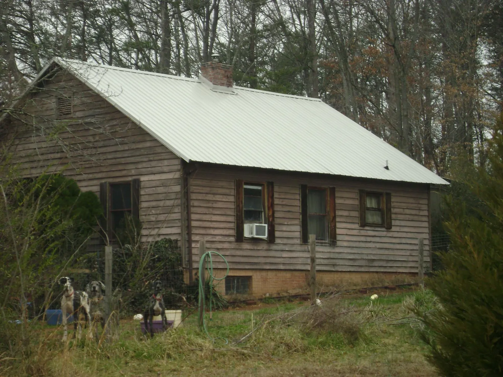 White metal roof on an old wood sided farmhouse, from a Metal Roof Installation job in Deer Grove